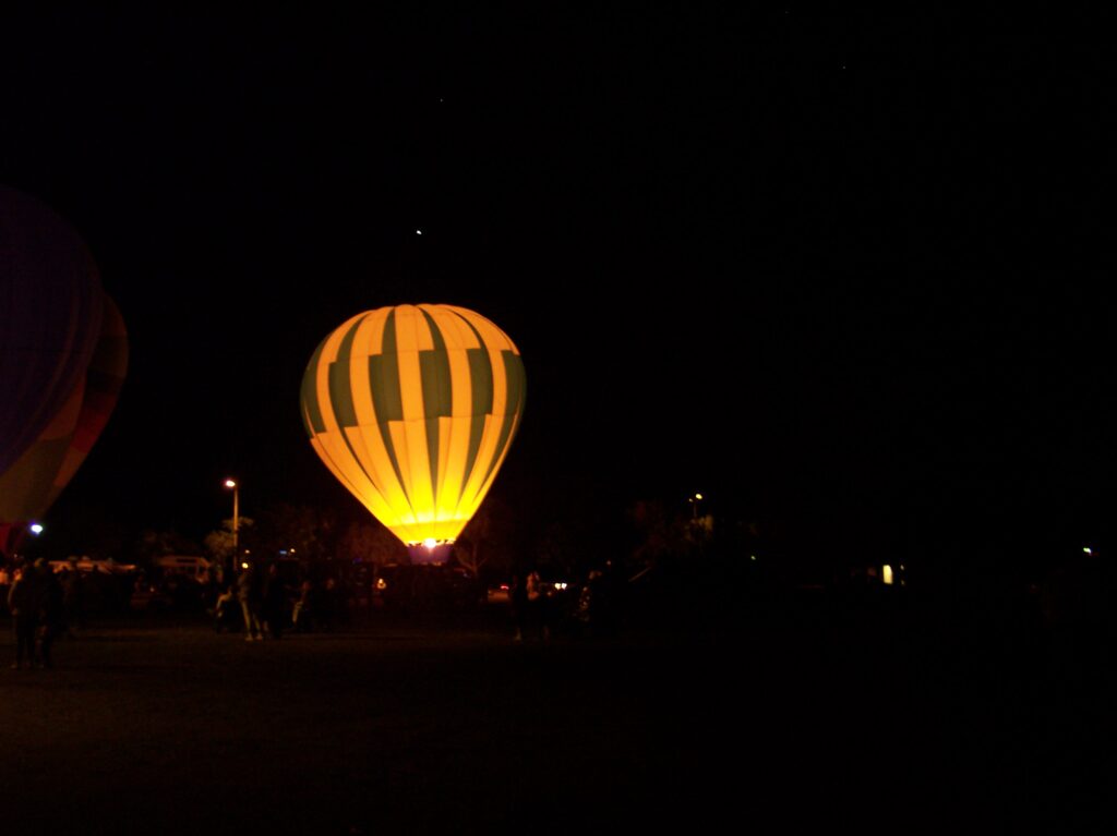 Hot air ballon taking off at night.